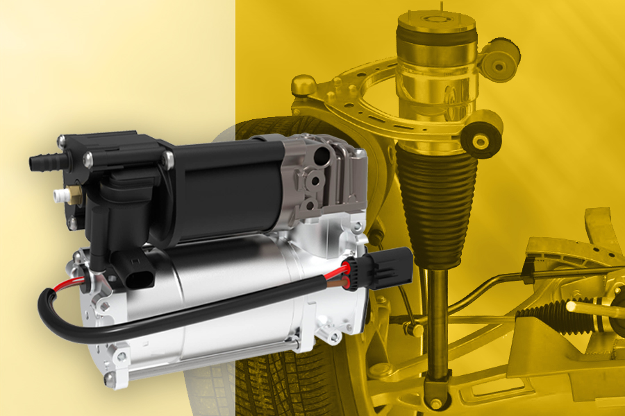 Compressor para suspensões pneumáticas da Magneti Marelli Parts & Services em destaque, com roda, eixo e sistema de suspensão a ar ao fundo para contextualizar a aplicação do componente
